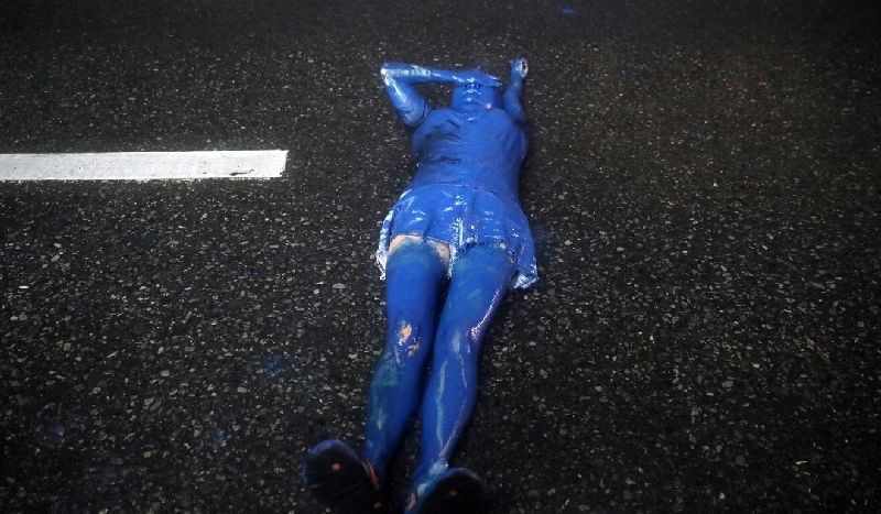 A pro-democracy activist covered in blue paint lies on the ground during an anti-government protest, in Bangkok, Thailand October 17, 2020. REUTERS/Soe Zeya Tun TPX IMAGES OF THE DAY